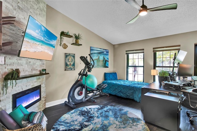 12219 Steppingstone Blvd, Tampa, FL 33635 - bedroom with lofted ceiling, wood finished floors, a stone fireplace, a textured ceiling, and baseboards