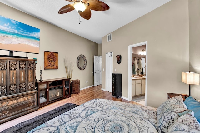 12219 Steppingstone Blvd, Tampa, FL 33635 - bedroom with wood finished floors, ensuite bathroom, baseboards, vaulted ceiling, and a ceiling fan