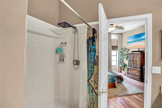 12219 Steppingstone Blvd, Tampa, FL 33635 - bathroom with a tile shower, wood finished floors, a ceiling fan, and connected bathroom