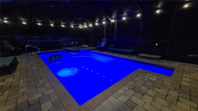 12219 Steppingstone Blvd, Tampa, FL 33635 - pool at night with an in-ground hot tub, a patio, and an outdoor pool
