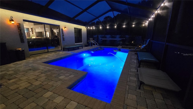 12219 Steppingstone Blvd, Tampa, FL 33635 - pool at night featuring a jacuzzi, an outdoor pool, a patio, and a lanai