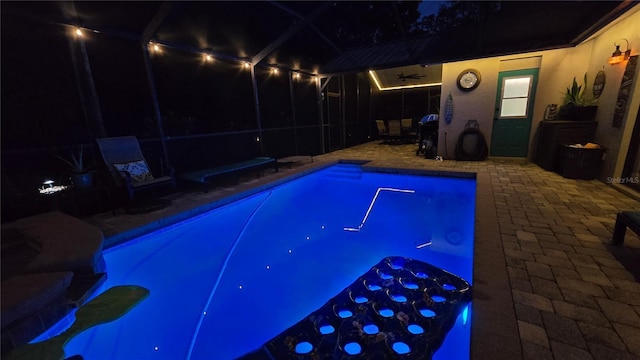 12219 Steppingstone Blvd, Tampa, FL 33635 - pool at night featuring a patio, an outdoor pool, ceiling fan, and a lanai