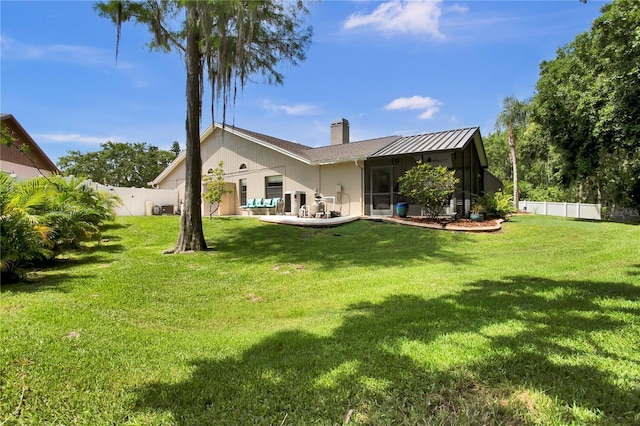 12219 Steppingstone Blvd, Tampa, FL 33635 - rear view of property featuring a chimney, a standing seam roof, and metal roof
