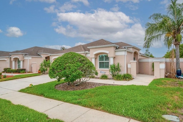 241 Royal Palm Way, Spring Hill, FL 34608 - mediterranean / spanish-style house with concrete driveway, stucco siding, and a front yard