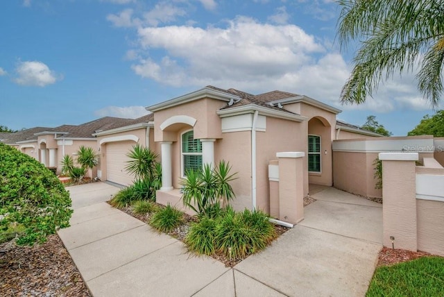 241 Royal Palm Way, Spring Hill, FL 34608 - mediterranean / spanish-style house featuring concrete driveway, an attached garage, and stucco siding