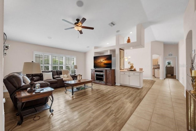 241 Royal Palm Way, Spring Hill, FL 34608 - living area with a ceiling fan, arched walkways, light wood-style floors, and high vaulted ceiling
