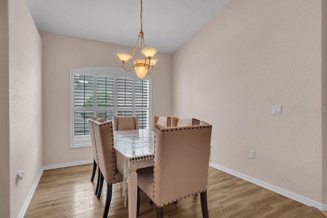 241 Royal Palm Way, Spring Hill, FL 34608 - dining room with a chandelier, light wood-style floors, and baseboards