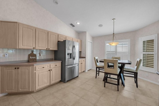 241 Royal Palm Way, Spring Hill, FL 34608 - kitchen featuring stainless steel fridge with ice dispenser, light brown cabinetry, lofted ceiling, tasteful backsplash, and pendant lighting