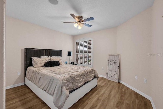241 Royal Palm Way, Spring Hill, FL 34608 - bedroom with wood finished floors, baseboards, and a ceiling fan