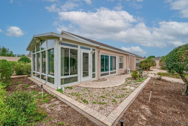 241 Royal Palm Way, Spring Hill, FL 34608 - rear view of house featuring a sunroom and a patio area