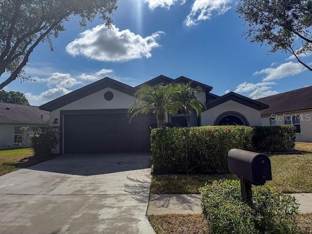 1716 Bondurant Way, Brandon, FL 33511 - ranch-style house with stucco siding, concrete driveway, and a garage