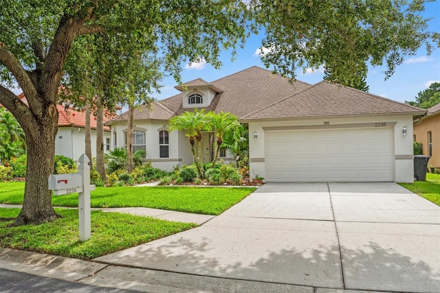 2238 Shirecrest Cove Way, Lutz, FL 33558 - view of front facade featuring stucco siding, an attached garage, driveway, and a front yard