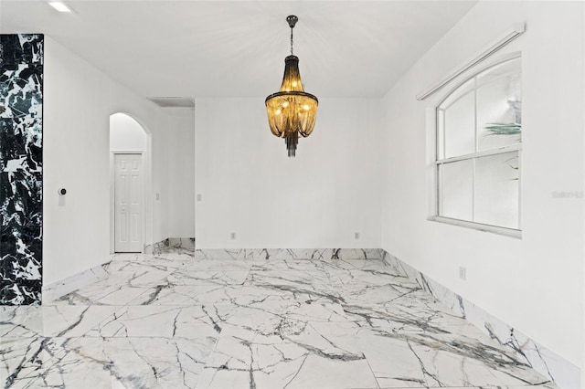 2238 Shirecrest Cove Way, Lutz, FL 33558 - unfurnished room featuring arched walkways, marble finish flooring, and a chandelier