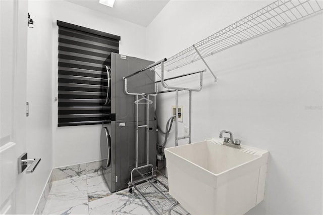 2238 Shirecrest Cove Way, Lutz, FL 33558 - laundry area with estacked washer and dryer, marble look tiles, and baseboards