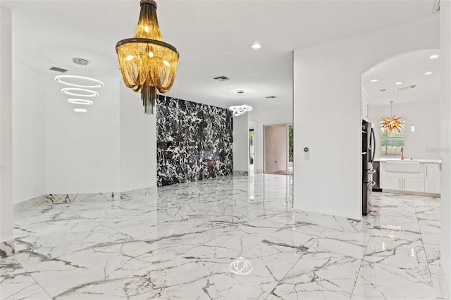 2238 Shirecrest Cove Way, Lutz, FL 33558 - unfurnished room with arched walkways, light marble finish floors, a chandelier, recessed lighting, and plenty of natural light