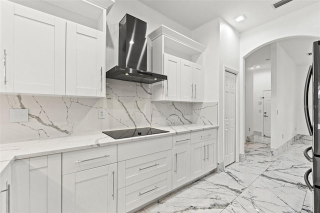 2238 Shirecrest Cove Way, Lutz, FL 33558 - kitchen featuring wall chimney exhaust hood, black electric stovetop, arched walkways, and white cabinetry