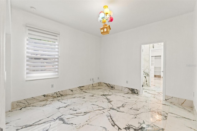 2238 Shirecrest Cove Way, Lutz, FL 33558 - empty room with light marble finish flooring, a chandelier, and a smoke detector