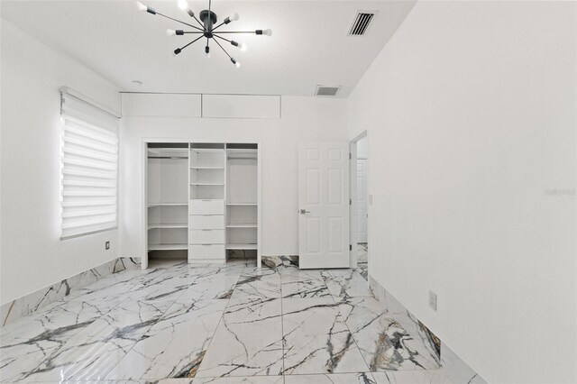 2238 Shirecrest Cove Way, Lutz, FL 33558 - unfurnished bedroom with a chandelier, a closet, and marble finish floors