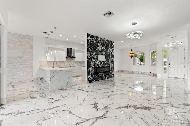 2238 Shirecrest Cove Way, Lutz, FL 33558 - living room featuring a chandelier, light marble finish flooring, a large fireplace, and recessed lighting