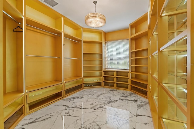 2238 Shirecrest Cove Way, Lutz, FL 33558 - spacious closet with marble tiled floors and a chandelier