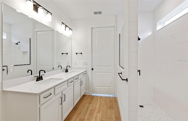8323 SW 58th Loop, Ocala, FL 34481 - full bathroom with double vanity, a walk in shower, and wood finished floors