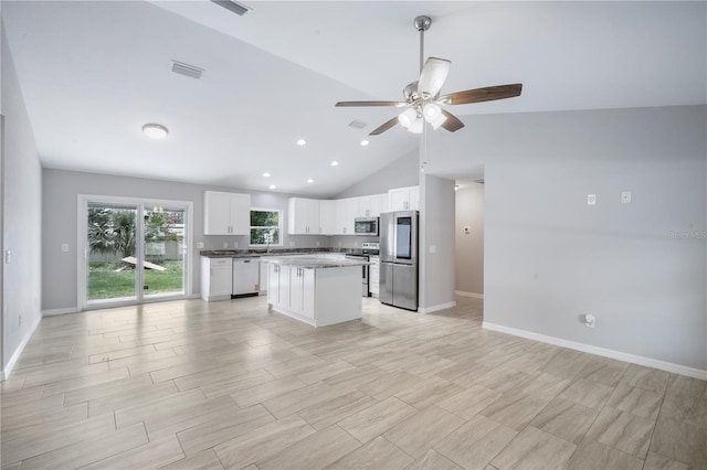 5319 Lantana St, Zephyrhills, FL 33542 - kitchen featuring stainless steel appliances, white cabinetry, a ceiling fan, a kitchen island, and open floor plan
