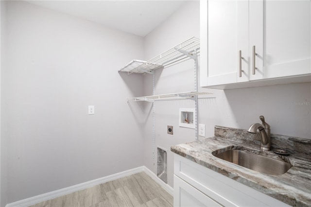 5319 Lantana St, Zephyrhills, FL 33542 - washroom with hookup for an electric dryer, cabinet space, washer hookup, baseboards, and light wood-type flooring