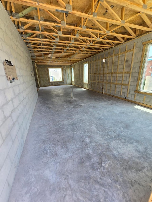 2932 Fairfield Ave S, Saint Petersburg, FL 33712 - misc room featuring unfinished concrete flooring, concrete block wall, and a garage