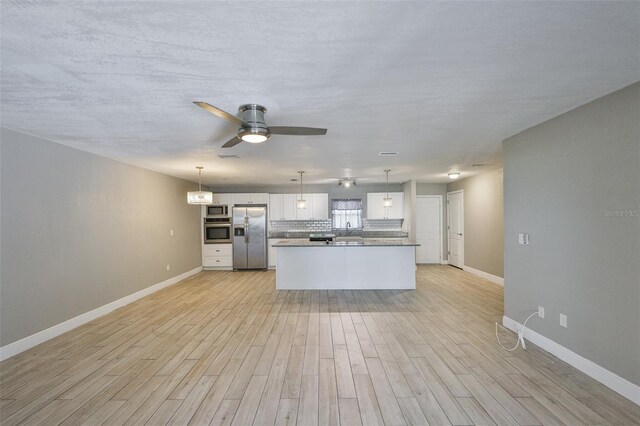 12372 113th St, Largo, FL 33778 - kitchen with stainless steel appliances, light wood-type flooring, baseboards, and ceiling fan