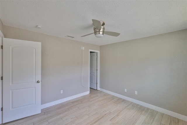 12372 113th St, Largo, FL 33778 - unfurnished bedroom with light wood-type flooring, baseboards, a textured ceiling, and a ceiling fan
