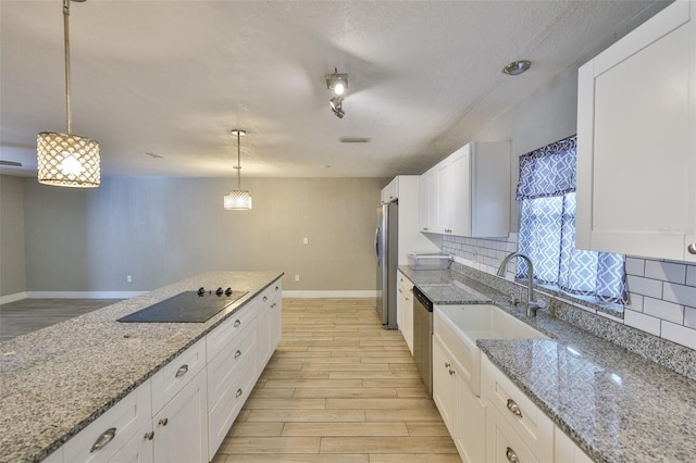12372 113th St, Largo, FL 33778 - kitchen with appliances with stainless steel finishes, tasteful backsplash, light wood-style floors, and baseboards