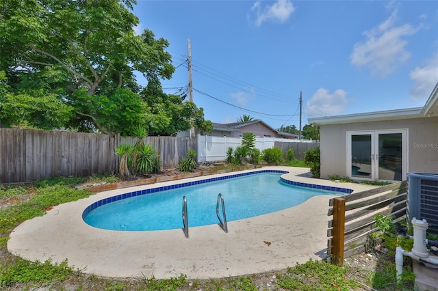 12372 113th St, Largo, FL 33778 - view of swimming pool with a fenced backyard, french doors, central air condition unit, and a patio area