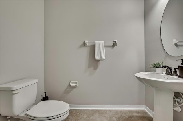 1821 Cherry Walk Rd, Lutz, FL 33558 - half bathroom featuring baseboards, toilet, and a sink