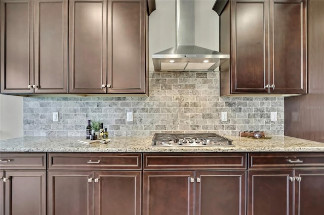 1821 Cherry Walk Rd, Lutz, FL 33558 - kitchen featuring wall chimney range hood, stainless steel gas stovetop, decorative backsplash, light stone countertops, and dark brown cabinetry