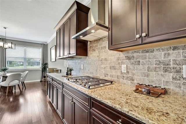 1821 Cherry Walk Rd, Lutz, FL 33558 - kitchen featuring wall chimney range hood, stainless steel gas stovetop, baseboards, backsplash, and light stone counters