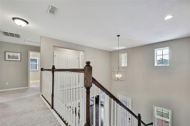 1821 Cherry Walk Rd, Lutz, FL 33558 - hallway with a chandelier, an upstairs landing, baseboards, and carpet flooring