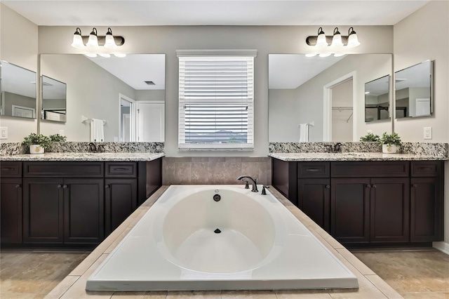 1821 Cherry Walk Rd, Lutz, FL 33558 - bathroom featuring two vanities and a garden tub