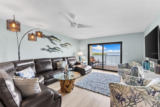 12525 3rd St E Unit 303, Treasure Island, FL 33706 - living area with wood finished floors and a ceiling fan