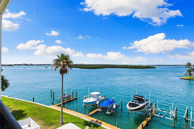 12525 3rd St E Unit 303, Treasure Island, FL 33706 - dock area featuring boat lift and a water view