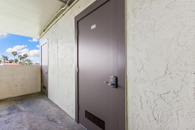 12525 3rd St E Unit 303, Treasure Island, FL 33706 - property entrance featuring stucco siding
