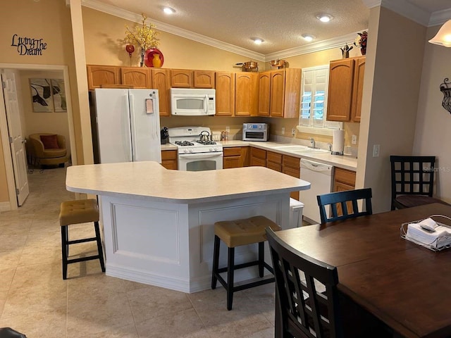 310 Knoll Pl, The Villages, FL 32162 - kitchen with white appliances, crown molding, a sink, light countertops, and a kitchen island