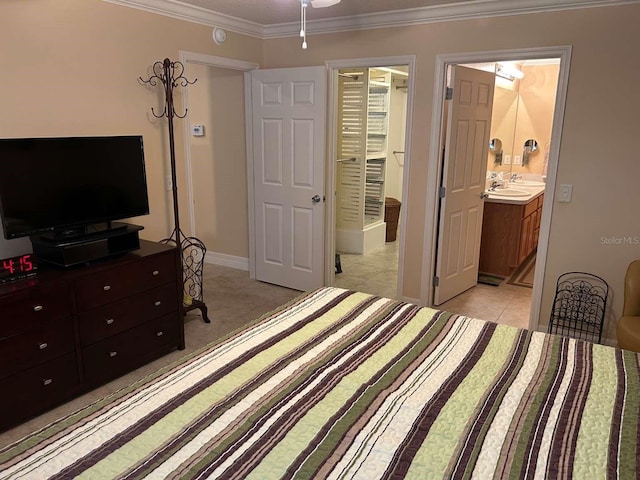 310 Knoll Pl, The Villages, FL 32162 - bedroom featuring crown molding, ensuite bathroom, light tile patterned flooring, a sink, and baseboards