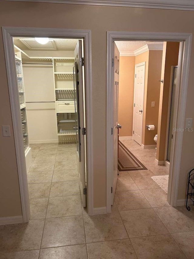 310 Knoll Pl, The Villages, FL 32162 - hall with light tile patterned floors, ornamental molding, and baseboards
