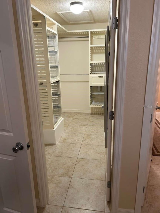 310 Knoll Pl, The Villages, FL 32162 - walk in closet with light tile patterned floors