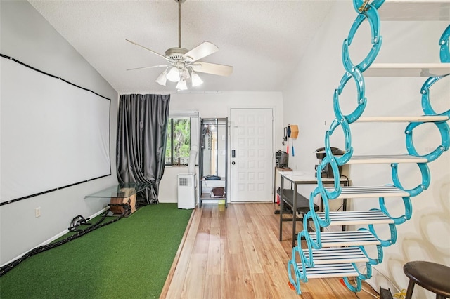 20921 Haulover Cv Unit 8, Lutz, FL 33558 - rec room featuring a ceiling fan, wood finished floors, a textured ceiling, and vaulted ceiling
