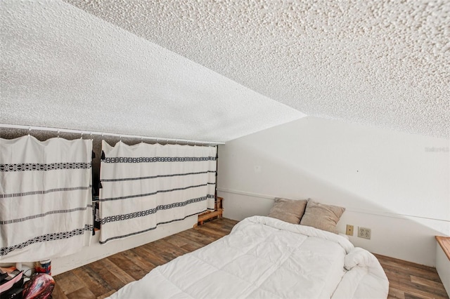 20921 Haulover Cv Unit 8, Lutz, FL 33558 - bedroom with a textured ceiling, wood finished floors, and lofted ceiling