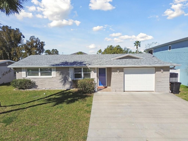 13323 Susan Dr, Hudson, FL 34667 - ranch-style home with concrete driveway, a garage, a front yard, brick siding, and roof with shingles