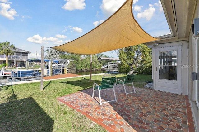 13323 Susan Dr, Hudson, FL 34667 - view of grassy yard with a water view and a patio