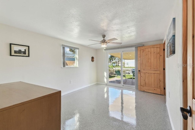 13323 Susan Dr, Hudson, FL 34667 - empty room featuring baseboards, ceiling fan, and a textured ceiling