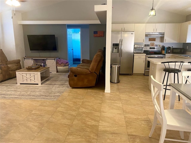 1602 Taylor Lake Cir, Largo, FL 33778 - kitchen featuring stainless steel appliances, vaulted ceiling, under cabinet range hood, white cabinetry, and open floor plan